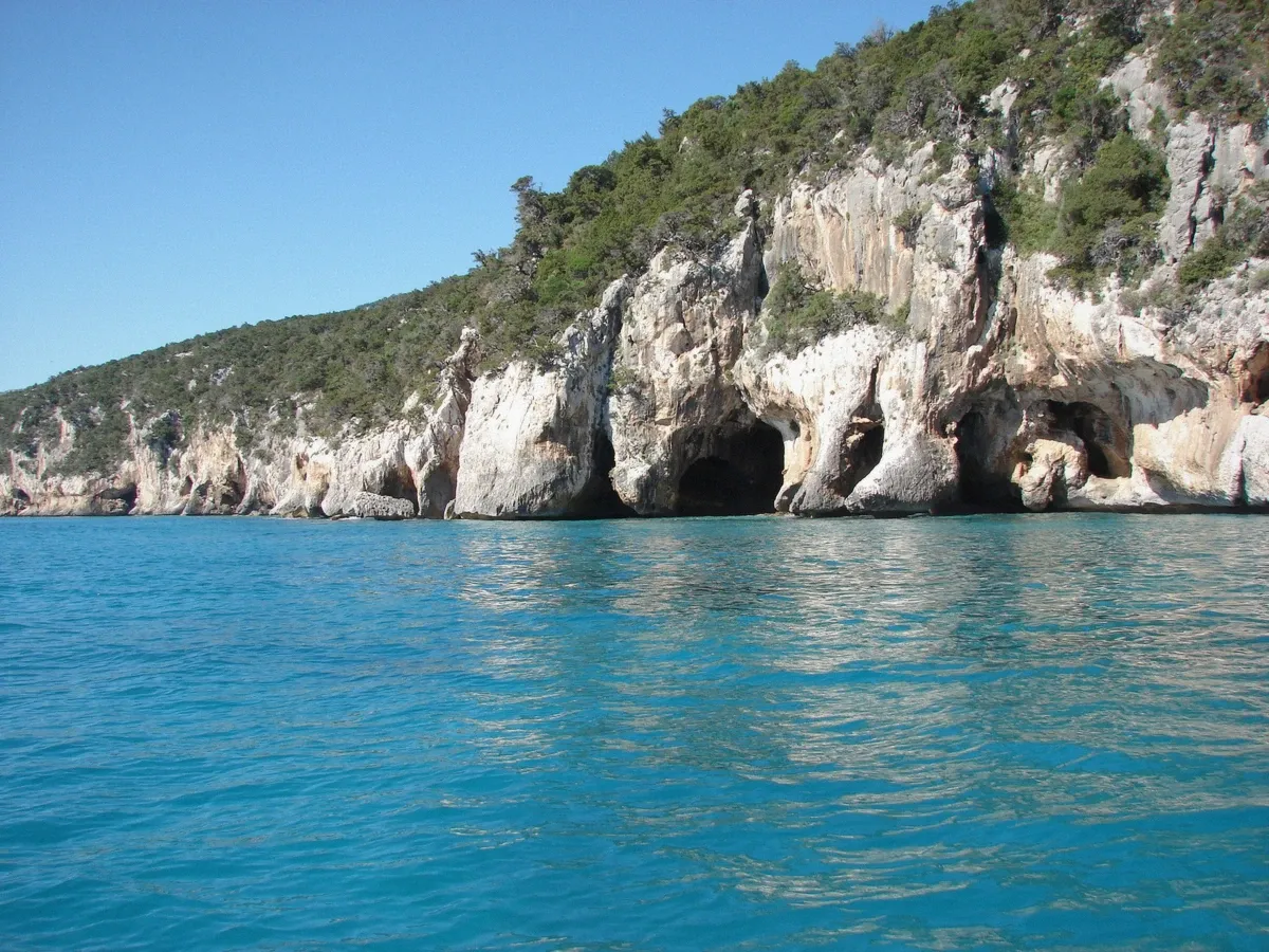 Sea cave mouth in Sardinian limestone, illustrative of the five caves on the Green Nautica Cagliari boat tour