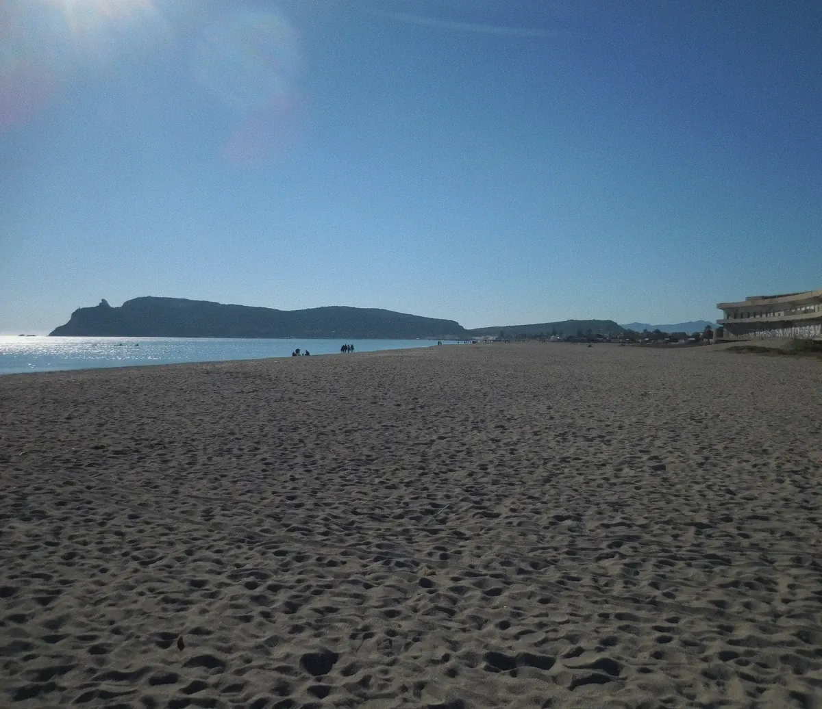 Poetto beach in Cagliari under blue skies, the 8 km sand that frames the boat tour season in Sardinia