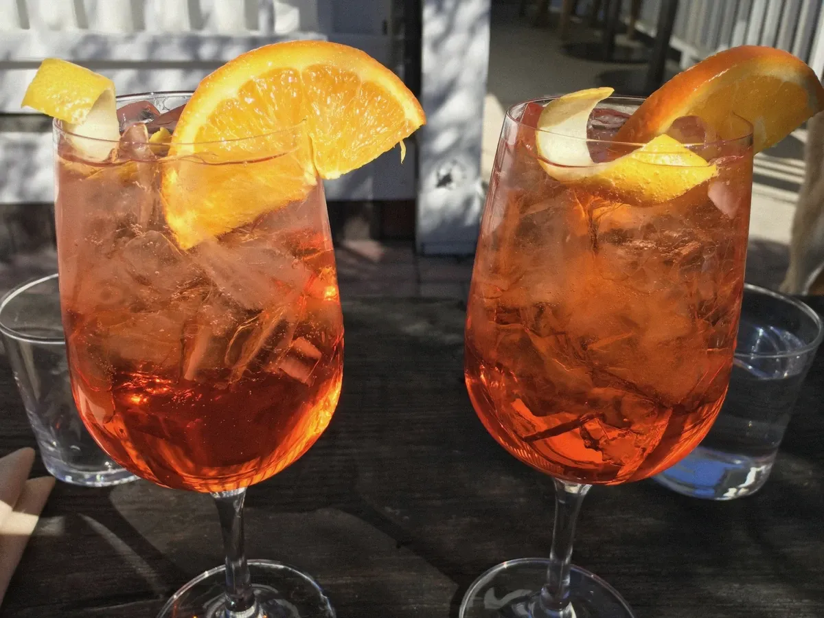 Aperitivo spritz glasses on a table, the drink ritual that closes a Cagliari boat day
